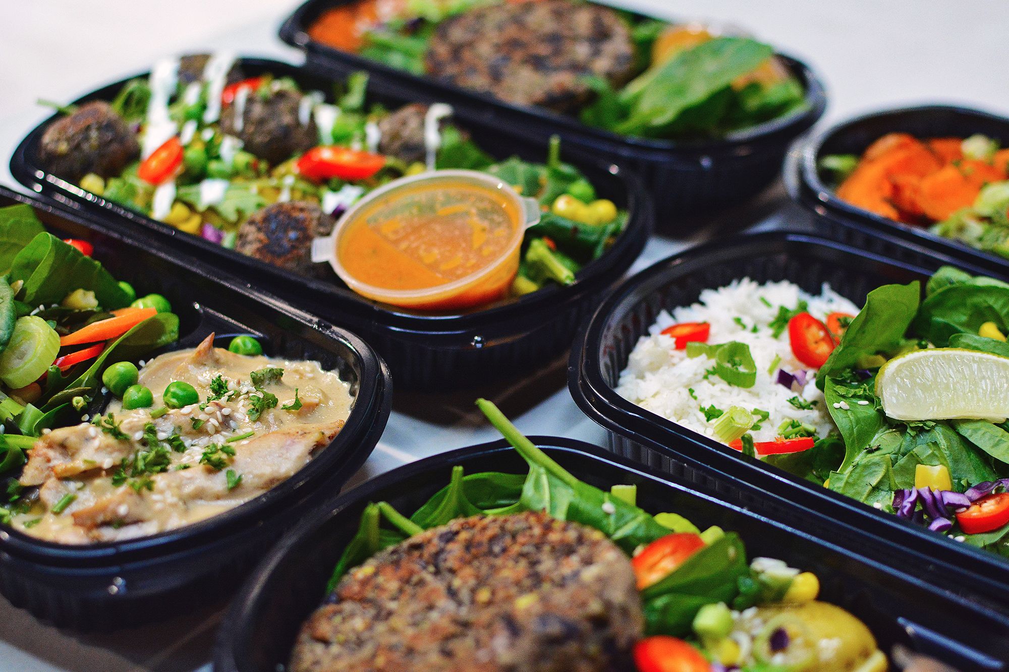 Selection of high-protein and low-carb meal prep corporate meals delivered in Huddersfield by Bosuprep for corporate wellbeing and productivity